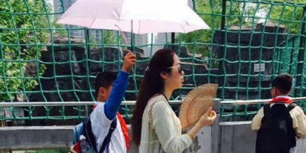 小學生為女教師打陽傘 小學生為女教師打陽傘